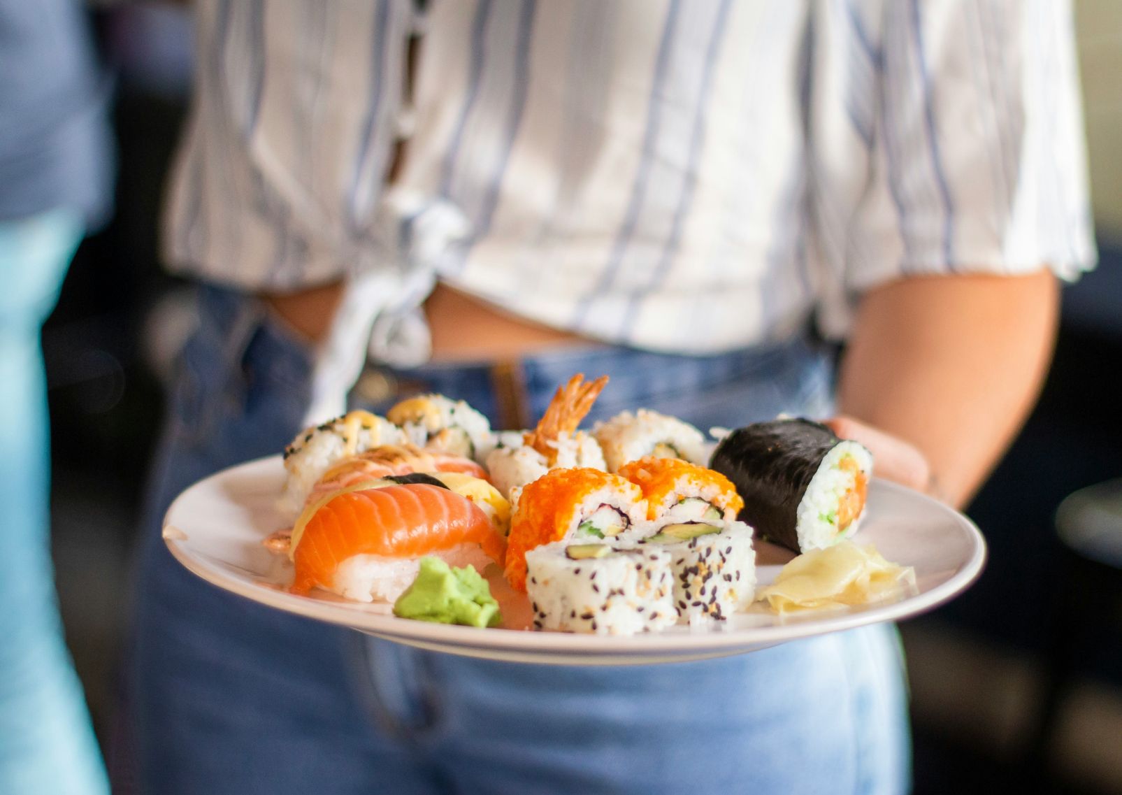 Woman serving fresh sushi, Japan