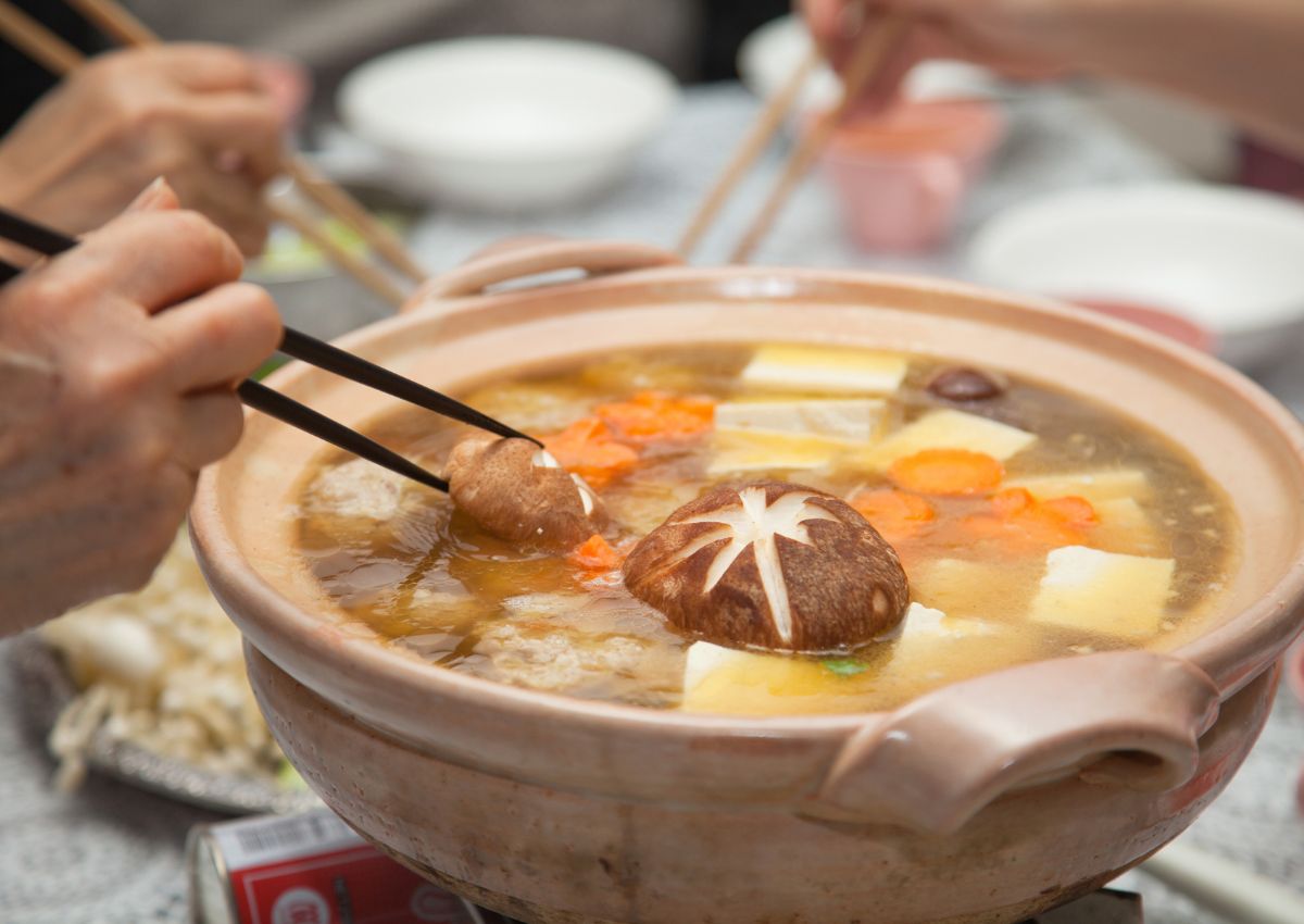 Dampende japansk nabe hot pot i gryte på bordet